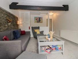 A living room with a sofa and coffee table at Courtyard Cottage
