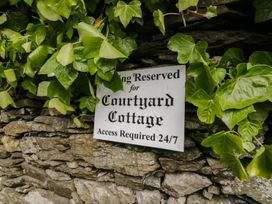 A reserved parking sign for Courtyard Cottage with ivy at Courtyard Cottage
