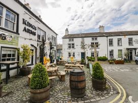 An outdoor area with tables and plants at Kings Arms pub