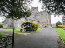 A church building with a pathway and greenery at Courtyard Cottage 