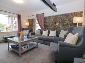 A living room with a sofa and coffee table at Courtyard Cottage in Cartmel
