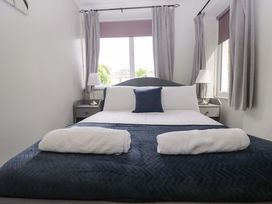 A bedroom with a bed and bedside table at Courtyard Cottage in Cartmel