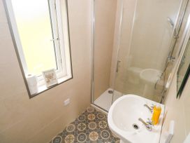 A shower and sink in a bathroom at Mayfly Cottage