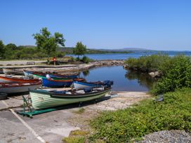 A dock with boats at a waterfront location at Mayfly Cottage