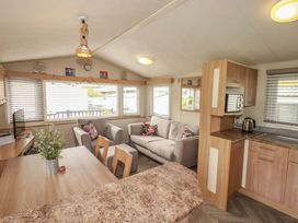 A mobile home interior with a sofa and kitchen area at Tucked Away in Newquay