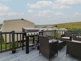 An outdoor area with a barbeque grill and seating at Tucked Away in Newquay