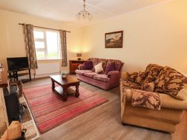 A living room with a sofa and coffee table at Golf Club View in County Clare