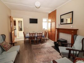 A dining room with a table and chairs at Golf Club View, County Clare