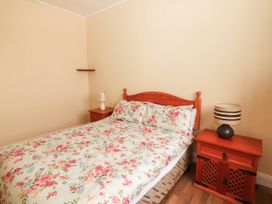 A bedroom with a bed and nightstand at Golf Club View in County Clare