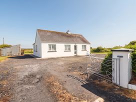 A house with a gate and driveway at Golf Club View, County Clare