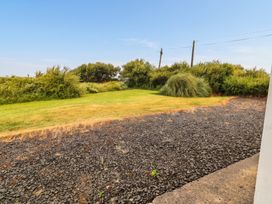 A garden area with grass and rocks at Golf Club View, County Clare