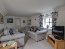 A living room with a sofa and television at Little Wickers in Wareham