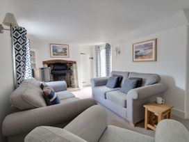 A living room with a sofa and television at Little Wickers in Wareham