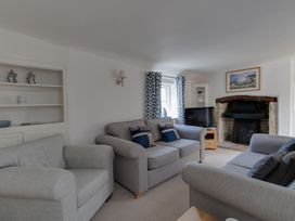 A living room with sofas and a television at Little Wickers in Wareham