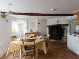 A kitchen with a table set for breakfast at Little Wickers in Wareham