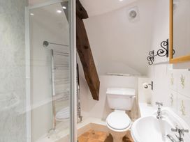 A bathroom with a shower, toilet, and sink at Little Wickers in Wareham