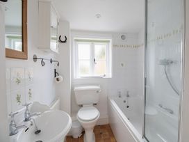 A bathroom with a sink, toilet, bathtub, and shower at Little Wickers in Wareham