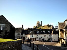 An outdoor view of buildings and a castle at Little Wickers in Wareham