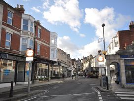 A street view with shops and traffic signs at Little Wickers in Wareham