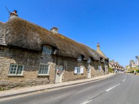 A street view of thatched cottages at Little Wickers in Corfe Castle