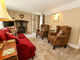 A living room with a sofa and armchairs at Little Wickers in Corfe Castle