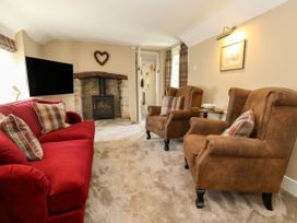 A living room with a sofa and armchairs at Little Wickers in Corfe Castle