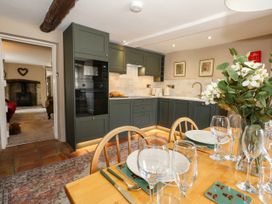 A kitchen with dining table and chairs at Little Wickers in Corfe Castle