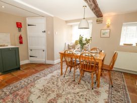 A dining room with a table and chairs at Little Wickers in Corfe Castle