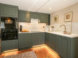 A kitchen with cabinets and appliances at Little Wickers in Corfe Castle
