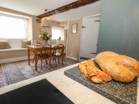 A dining room with a table and chairs at Little Wickers in Corfe Castle