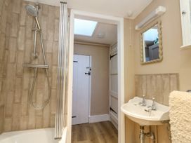 A bathroom with a shower and a sink at Little Wickers in Corfe Castle