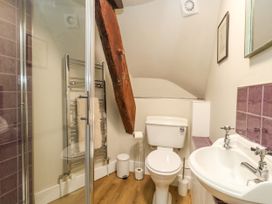 A bathroom with a shower, toilet and sink at Little Wickers in Corfe Castle