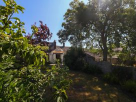 A garden with trees and a house at Little Wickers in Corfe Castle