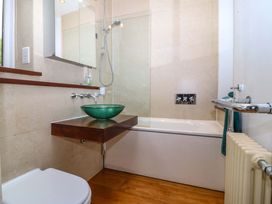 A bathroom with a sink, toilet, and bathtub at The Treehouse in Colwyn Bay