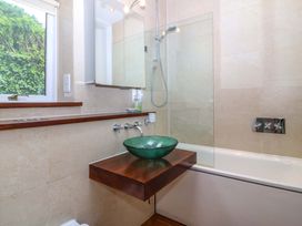 A bathroom with a bathtub and a sink at The Treehouse in Colwyn Bay