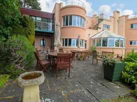 An outdoor area with a table and chairs at The Treehouse in Colwyn Bay