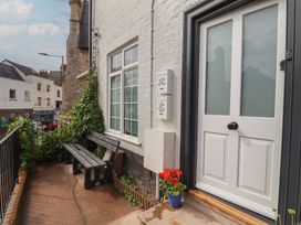 An outdoor area with a door and bench at Flat 1 Harley House Sidmouth