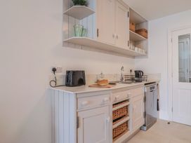 A kitchen with a sink and appliances at Flat 1 Harley House Sidmouth