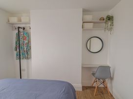 A bedroom with a bed and a desk at Flat 1 Harley House in Sidmouth