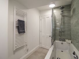 A bathroom with a bathtub and shower at Flat 1 Harley House in Sidmouth