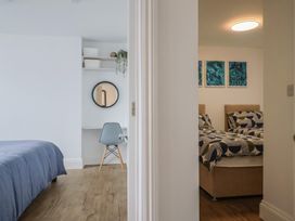 A bedroom with two beds and a desk at Flat 1 Harley House in Sidmouth