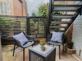 An outdoor seating area with two chairs and a table at Flat 1 Harley House Sidmouth