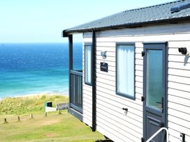 A house with a balcony overlooking the beach at 619 Chy-An-Mor in Perranporth