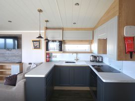 A kitchen with appliances and furniture at 619 Chy-An-Mor Perranporth