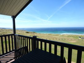 A balcony view overlooking the sea and hills at 619 Chy-An-Mor Perranporth