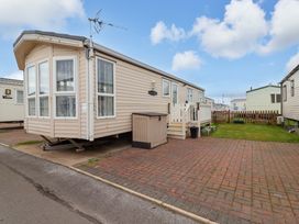 A caravan with steps and a fenced garden at Winchester - 478 Abergele