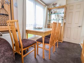A dining room with a table and chairs at Winchester - 478 Abergele