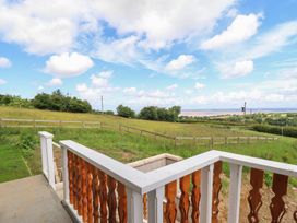 A view from a balcony overlooking a grassy field at Hay Loft at Ebenezer Chapel, Milwr