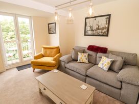 A living room with a sofa and armchair at Twyni Bach