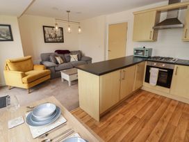 A kitchen and living area with furniture at Twyni Bach